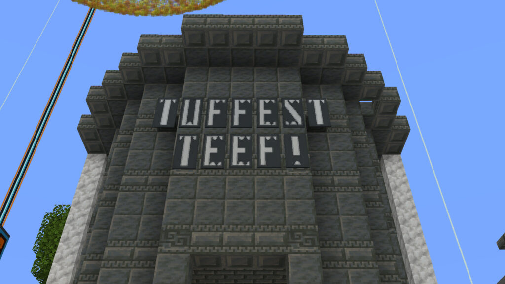 A screenshot of MineCraft showing the Tuff and Calcite shop’s sign, which reads “Tuffest Teef!” in banner text that looks like teeth