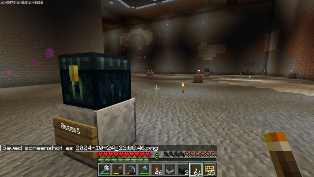 A screenshot of Minecraft showing a sign and enderchest marking one plot for Hermit History in ImpulseSV's cyberpunk city. Additional plots are similarly adorned receding into the background.