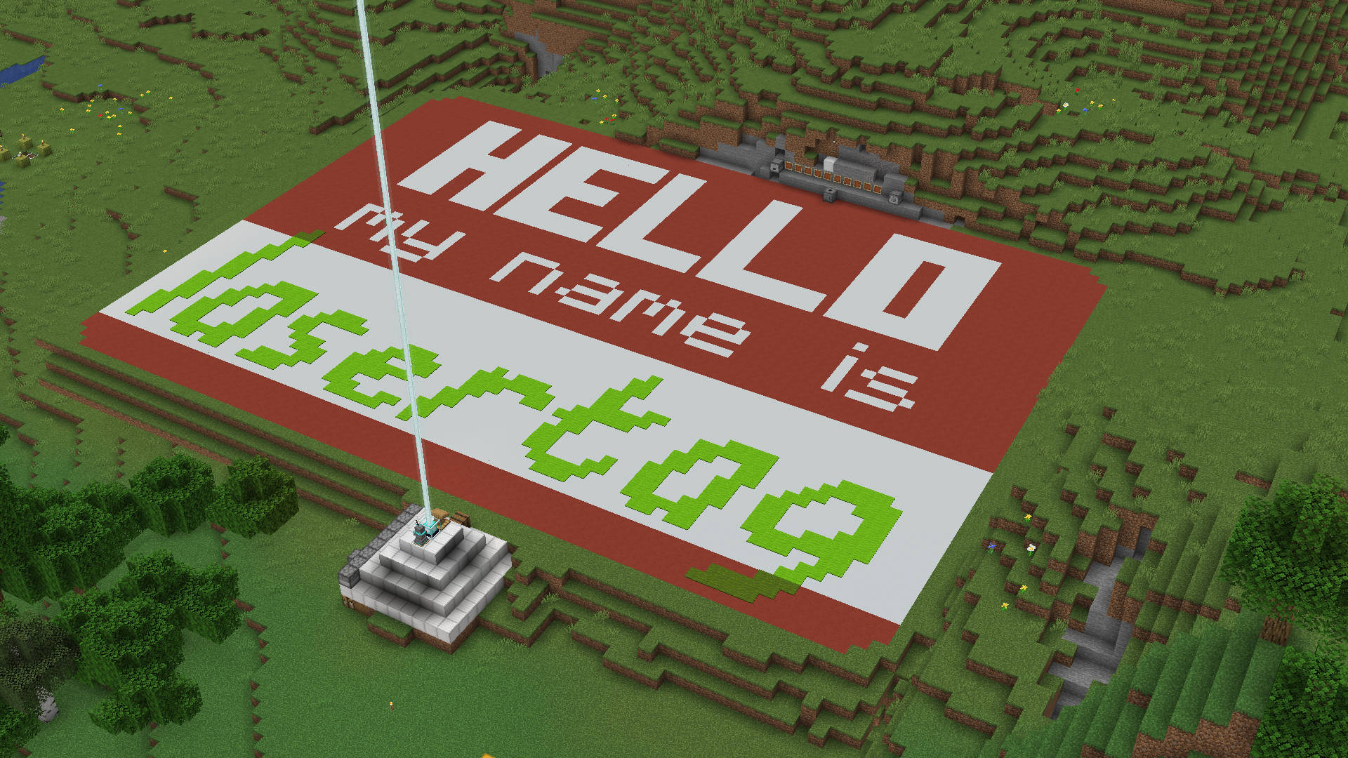 A screenshot of the game Minecraft showing an 80-meter wide concrete name tag that reads, "Hello my name is Lasertag"